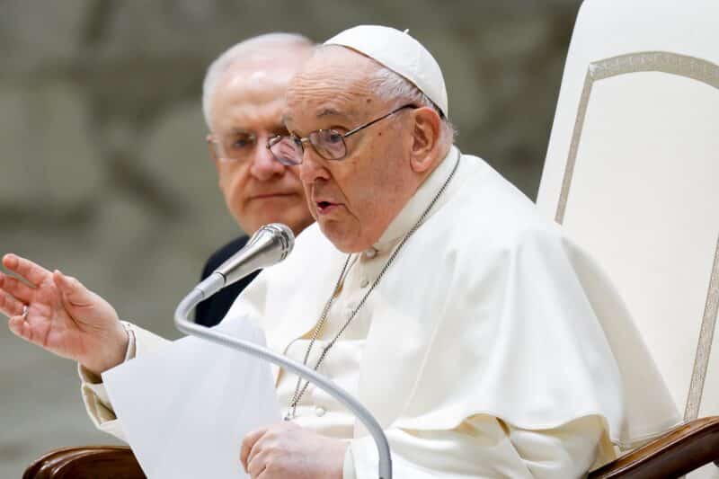 Pope Francis talks to visitors during his weekly general audience in the Paul VI Audience Hall at the Vatican Jan. 31, 2024. (CNS photo/Lola Gomez)